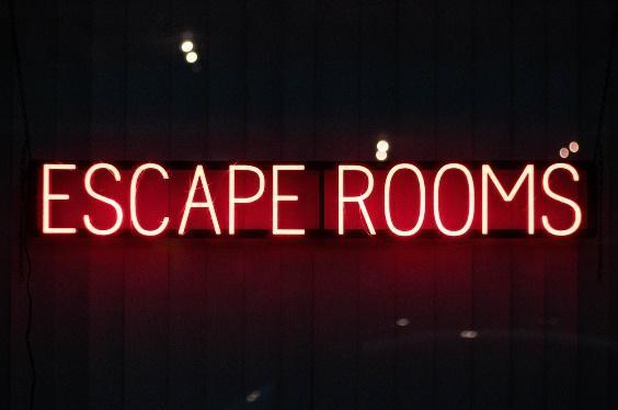 The word 'Escape Rooms' in neon writing.