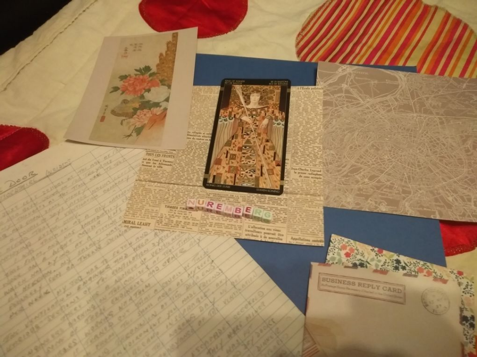 Photo of collage of maps, news paper clippings, notes and image of woman wearing a collage dress