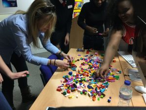 Students using Lego bricks to explain different types of journalistic formats