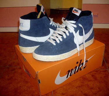 A photo of a pair of new Nike high-top Blazer trainers arranged on top of a shoebox.