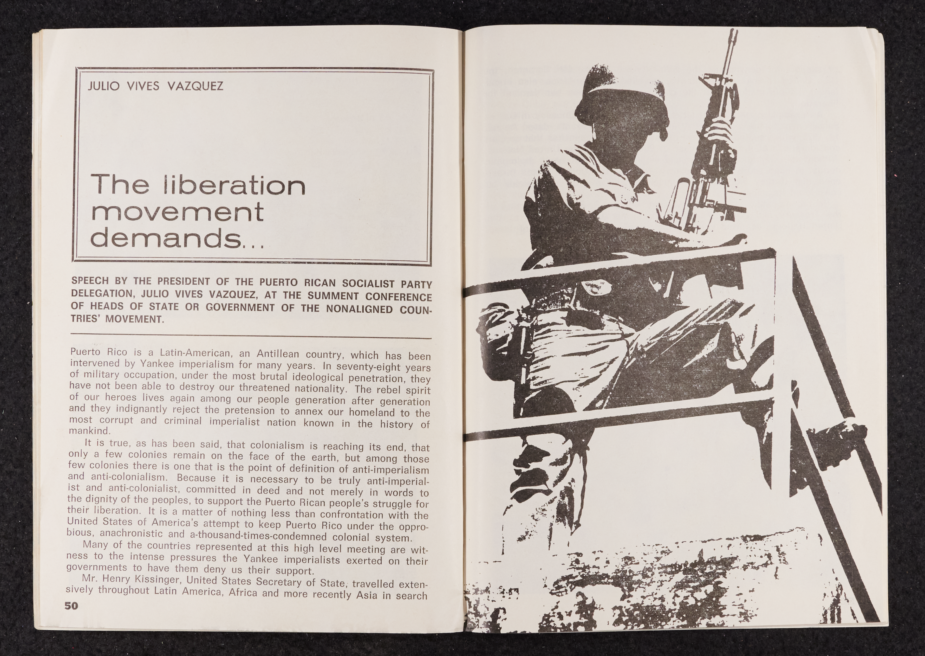 Image credit: Copyright OSPAAAL (1977). Tricontinental Review, no. 103 (1977), pp. 50-51. Accessed via British Library for Development Studies Legacy Collection. Scan courtesy University of Sussex (2024). All rights reserved. A booklet open on a double-page spread. The left-hand side is the first page of an article titled 'The liberation movement demands...'. The right-hand side is a black and white image of a soldier holding a rifle with his foot on a railing.