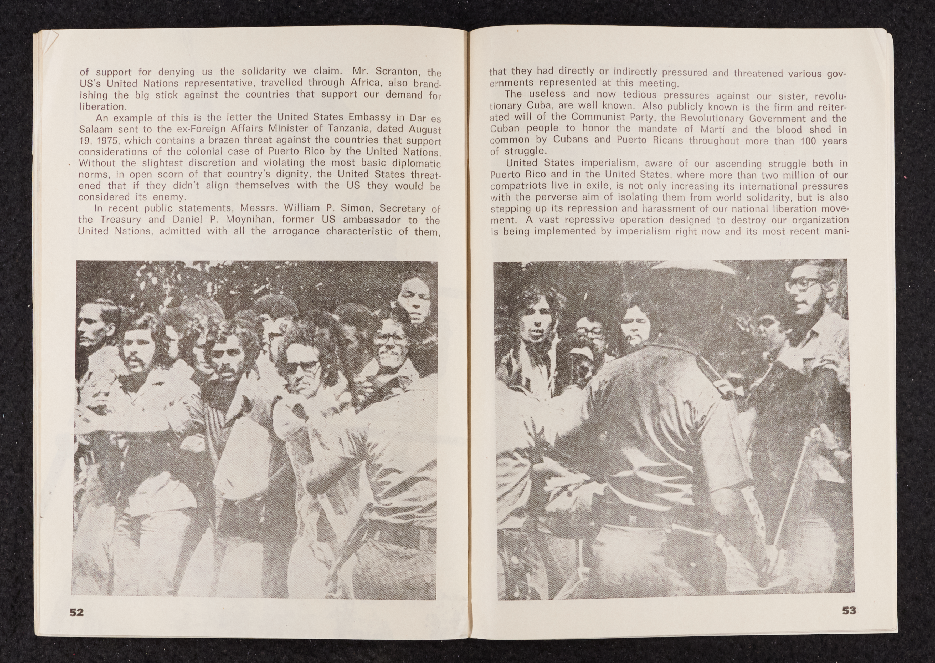 Image credit: Copyright OSPAAAL (1977). Tricontinental Review, no. 103 (1977), pp. 52-53. Accessed via British Library for Development Studies Legacy Collection. Scan courtesy University of Sussex (2024). All rights reserved. A booklet open on a double-page spread. Both pages have text in the top third of the page and half of the same photo in the bottom third of the page.The photo is a black and white photo of a group of young men being motioned back by armed guards or soldiers. It could be the scene of a demonstration.