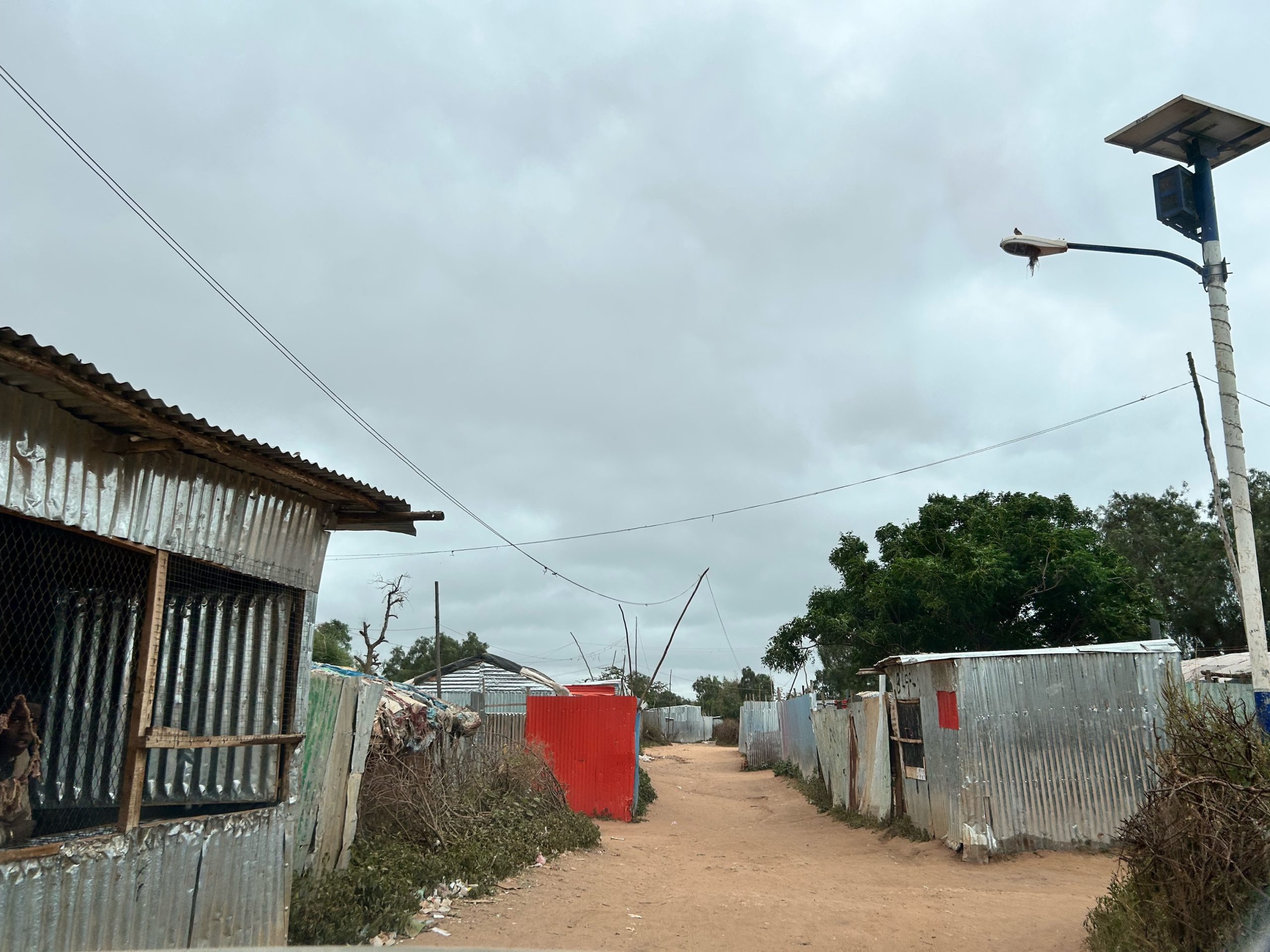 Photo of a camp with houses built from corrugated metal.
